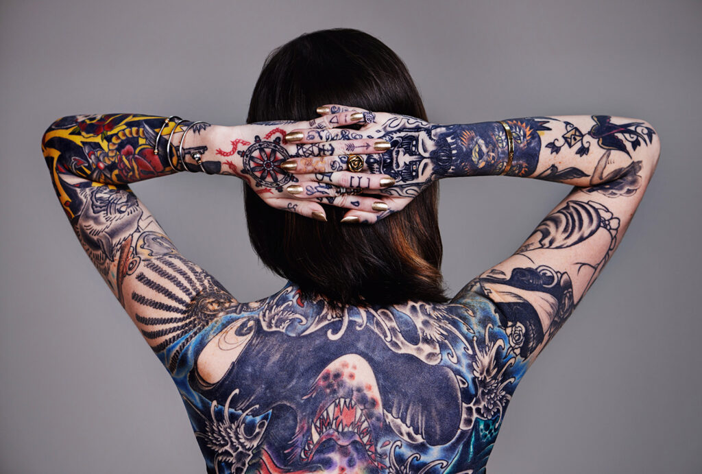 Women facing backwards showing off tattoos